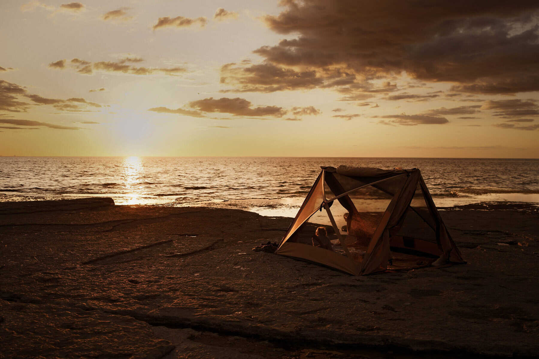 GoldFerse, Strandzelt am Meer bei Sonnenuntergang, entspannte Urlaubsstimmung, Sommerurlaub, Natur, Freiheit, Goldenes Licht, Ruhe, Sommernacht, Meeresrauschen, Outdoor-Erlebnis, Erholung am Strand, perfekte Sonnenuntergangs-Kulisse, Naturliebhaber, Reisefotografie, Sommerabend, Entspannungsort, Naturerlebnis, Urlaub am Wasser, Sonnenuntergang über dem Meer, Urlaubsstimmung.